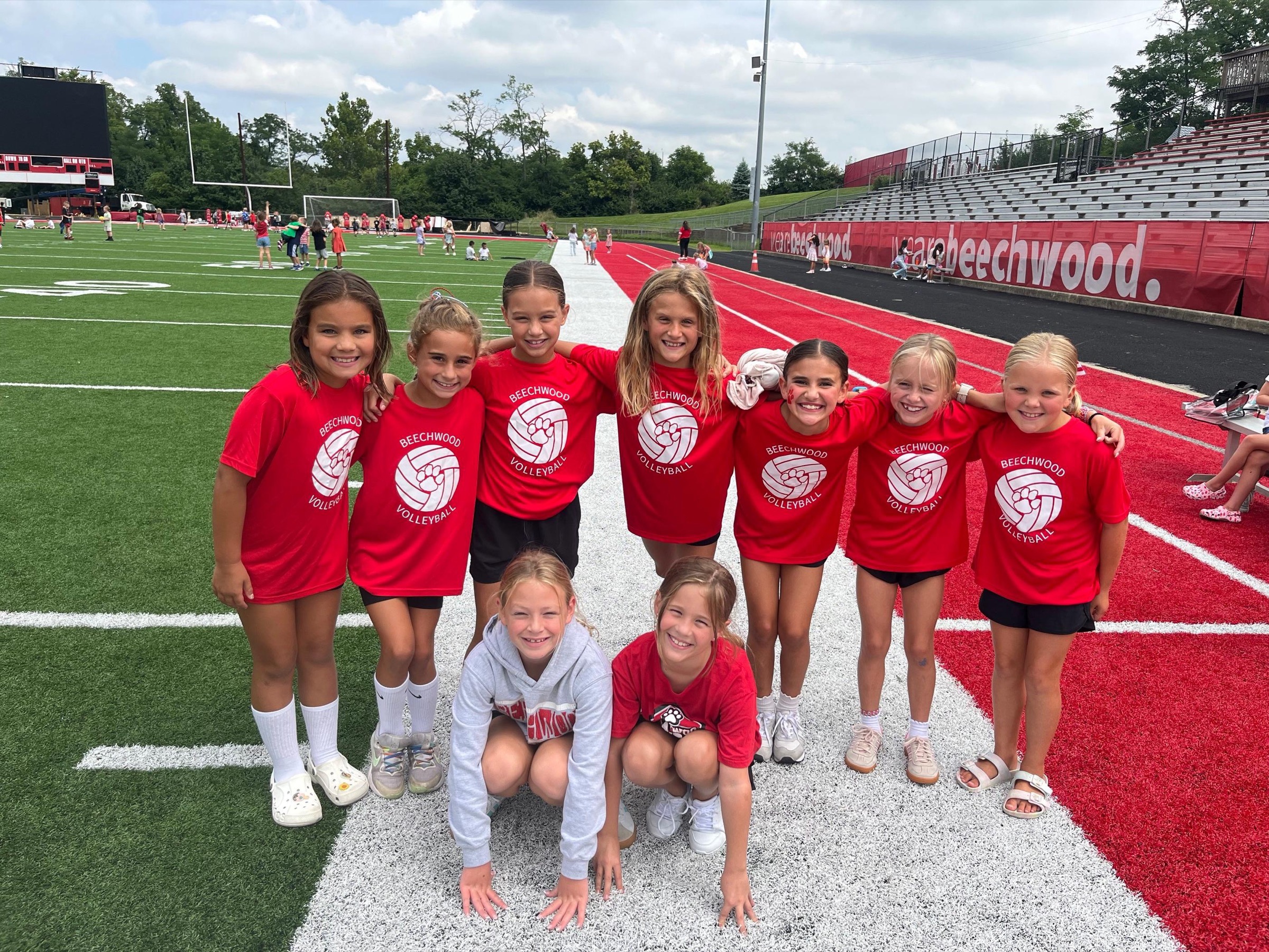 Students in volleyball shirts on the field